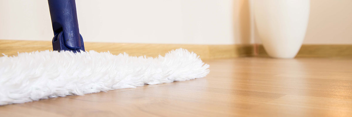 fluffy white duster sweeping on hardwood floors