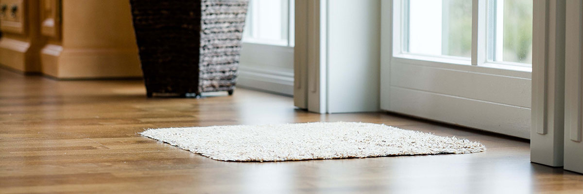 hardwood flooring with white doormat