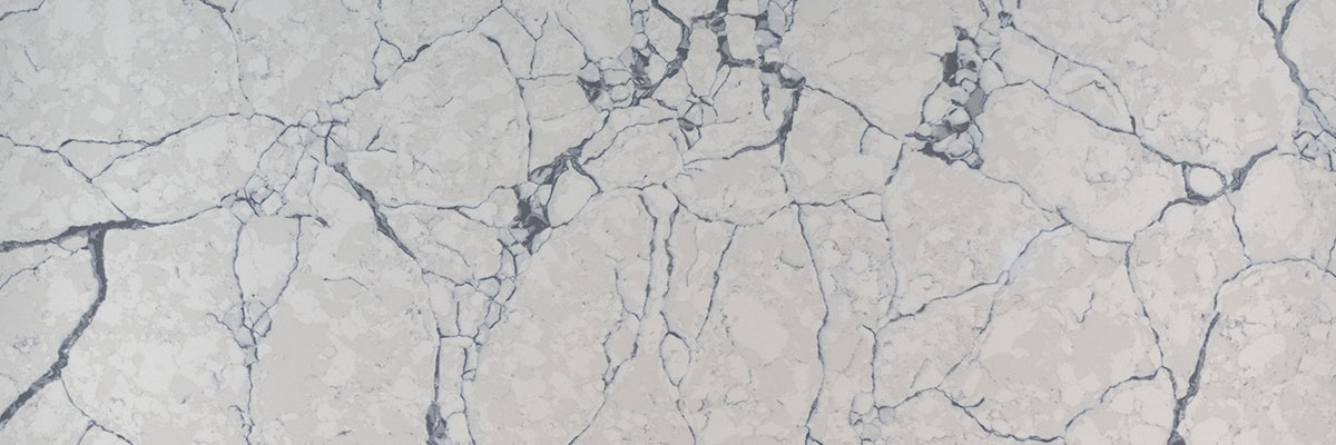 calacatta lago quartz slab with white background and blue veins