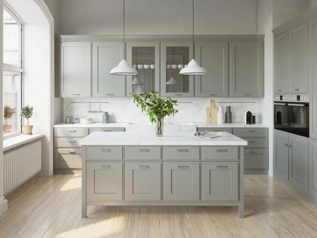 grey kitchen cabinets with white countertops and vase with greenery